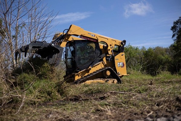 Land clearing equipment removing thick brush and overgrown vegetation from rural land in York County new view